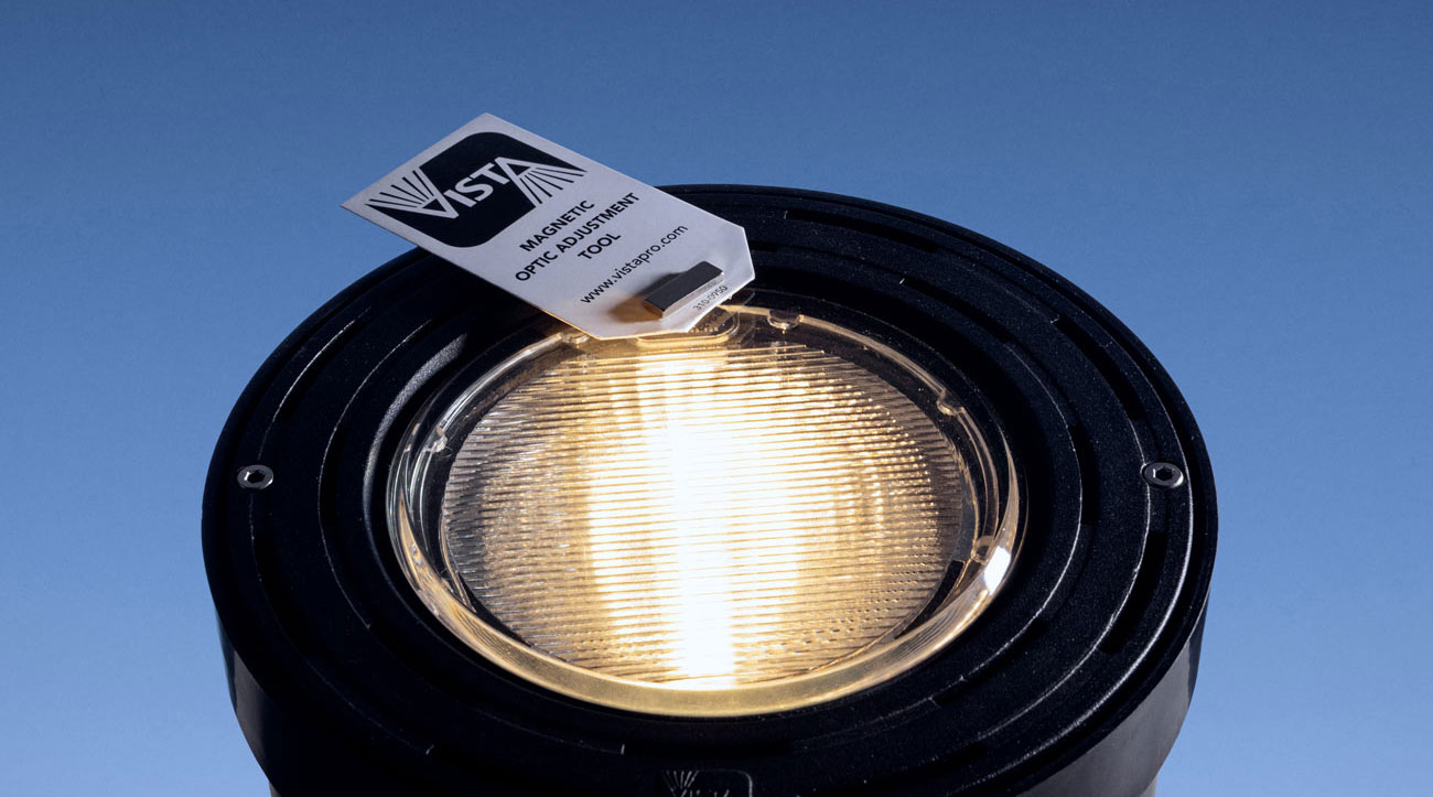 A close-up photo showing Vista Professional's magnetic hot aiming functionality on an outdoor light fixture