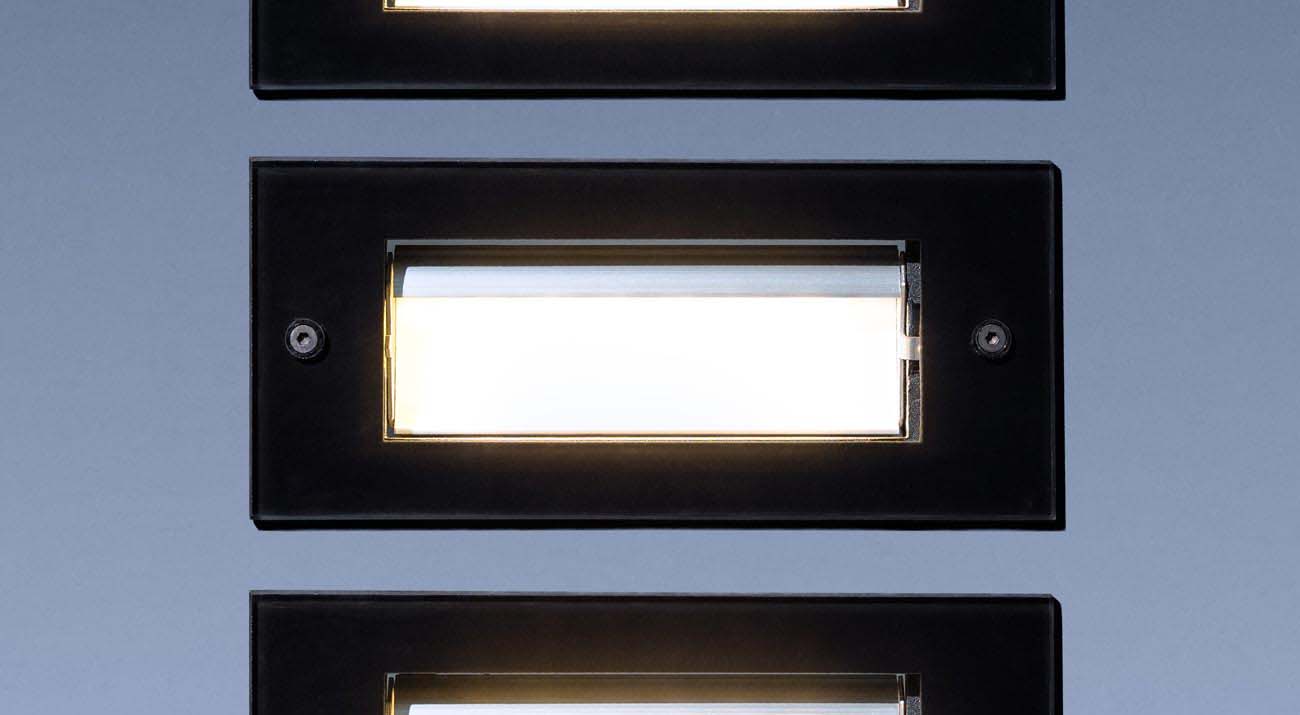 A close-up photo of three Vista Professional step lights shown with different aiming settings